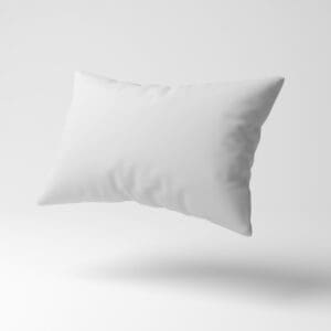 A pillow is floating in the air on top of a white surface.